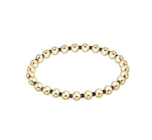 Gold beaded bracelet on a white background