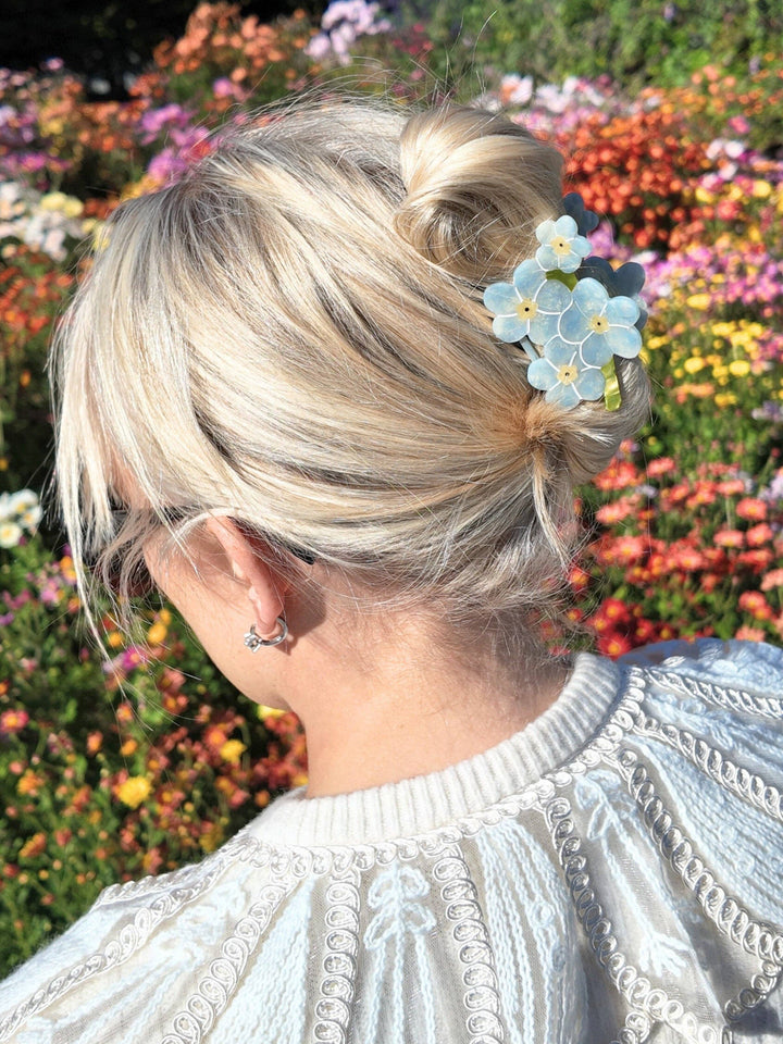 Forget Me Not Clip by Solar Eclipse, a delicate silver-toned gift clip with floral design, displayed against a soft background.