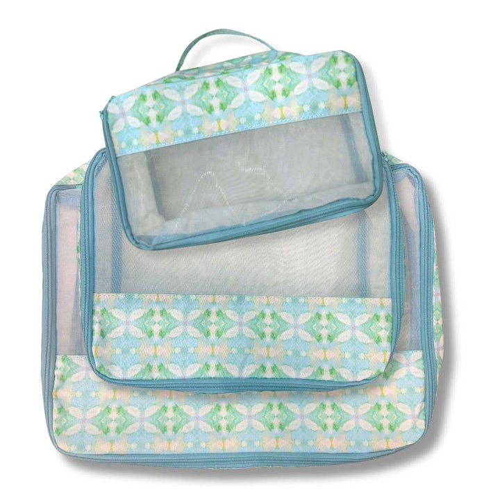 Laura Park Designs packing cubes gift set featuring colorful, organized travel storage bags on a white background.
