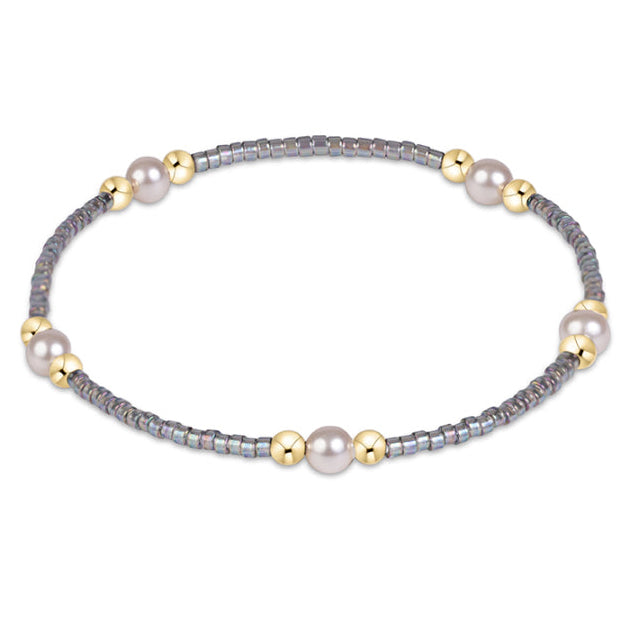 Enewton Hope Purpose Pearl Bracelet 26FW, elegant accessory with white pearls and silver accents, worn on a wrist.