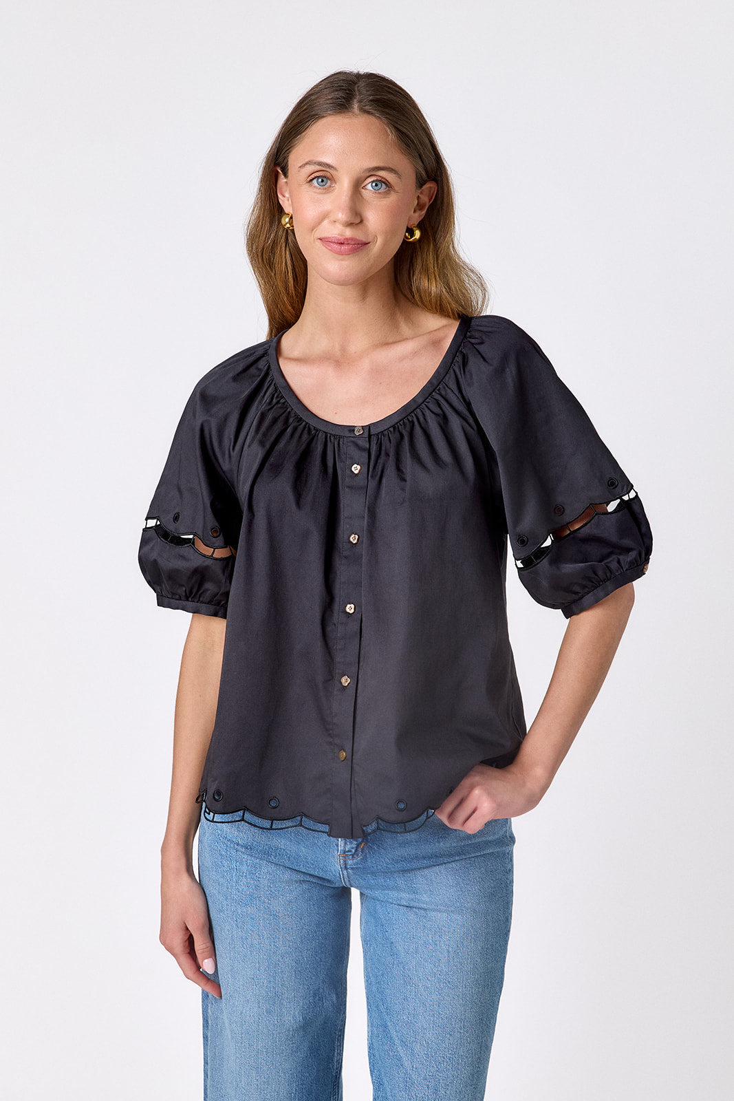 Black Crosby by Mollie Burch Perrie Top with long sleeves and a relaxed fit, displayed on a hanger.