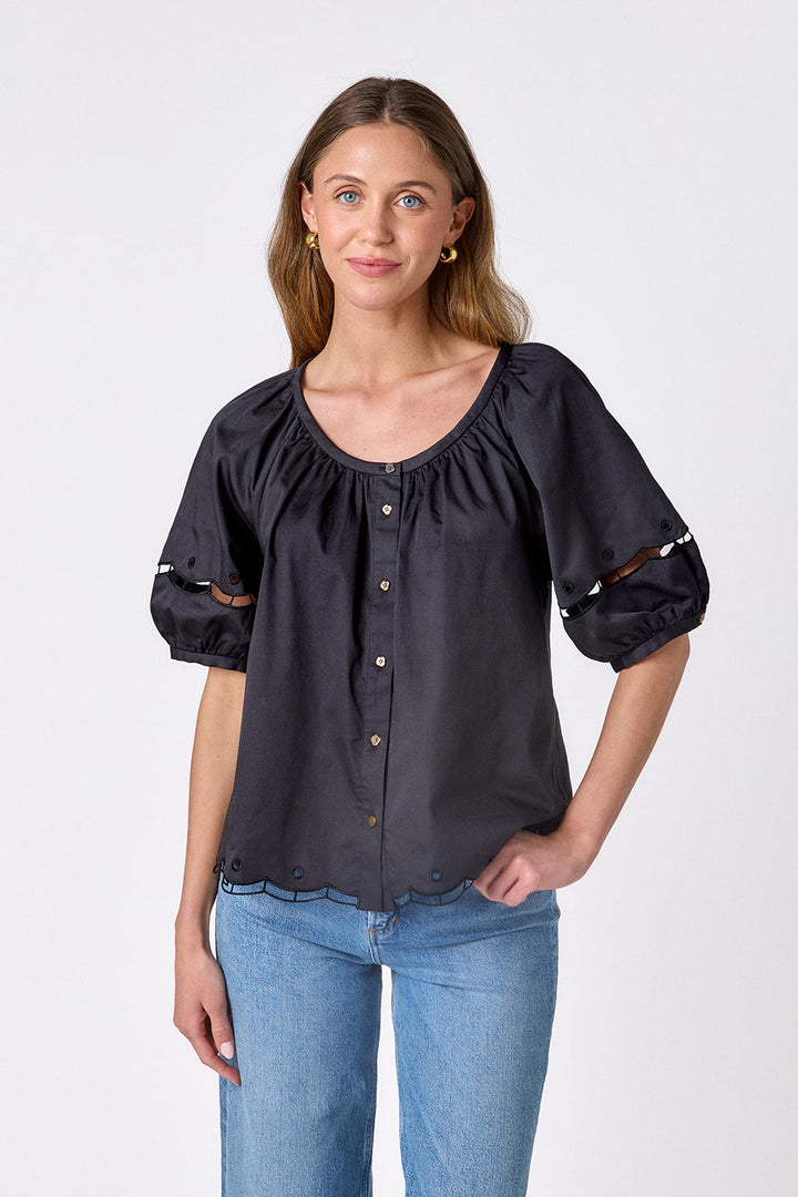 Black Crosby by Mollie Burch Perrie Top with long sleeves and a relaxed fit, displayed on a hanger.