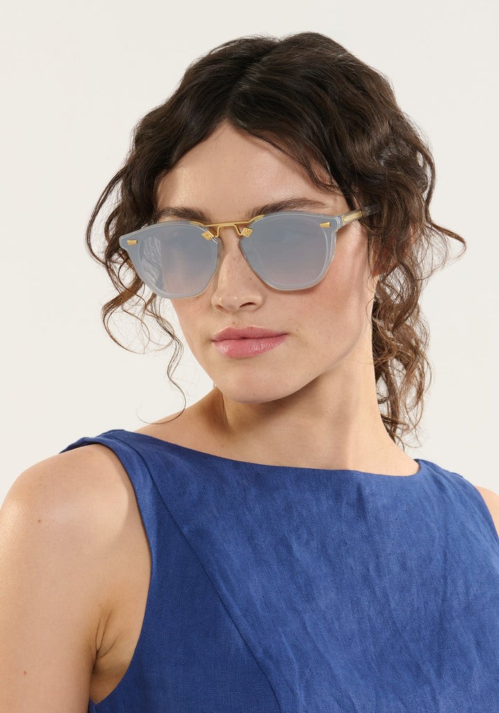 Model wearing KREWE Beau Nylon Powder Blue mirrored sunglasses