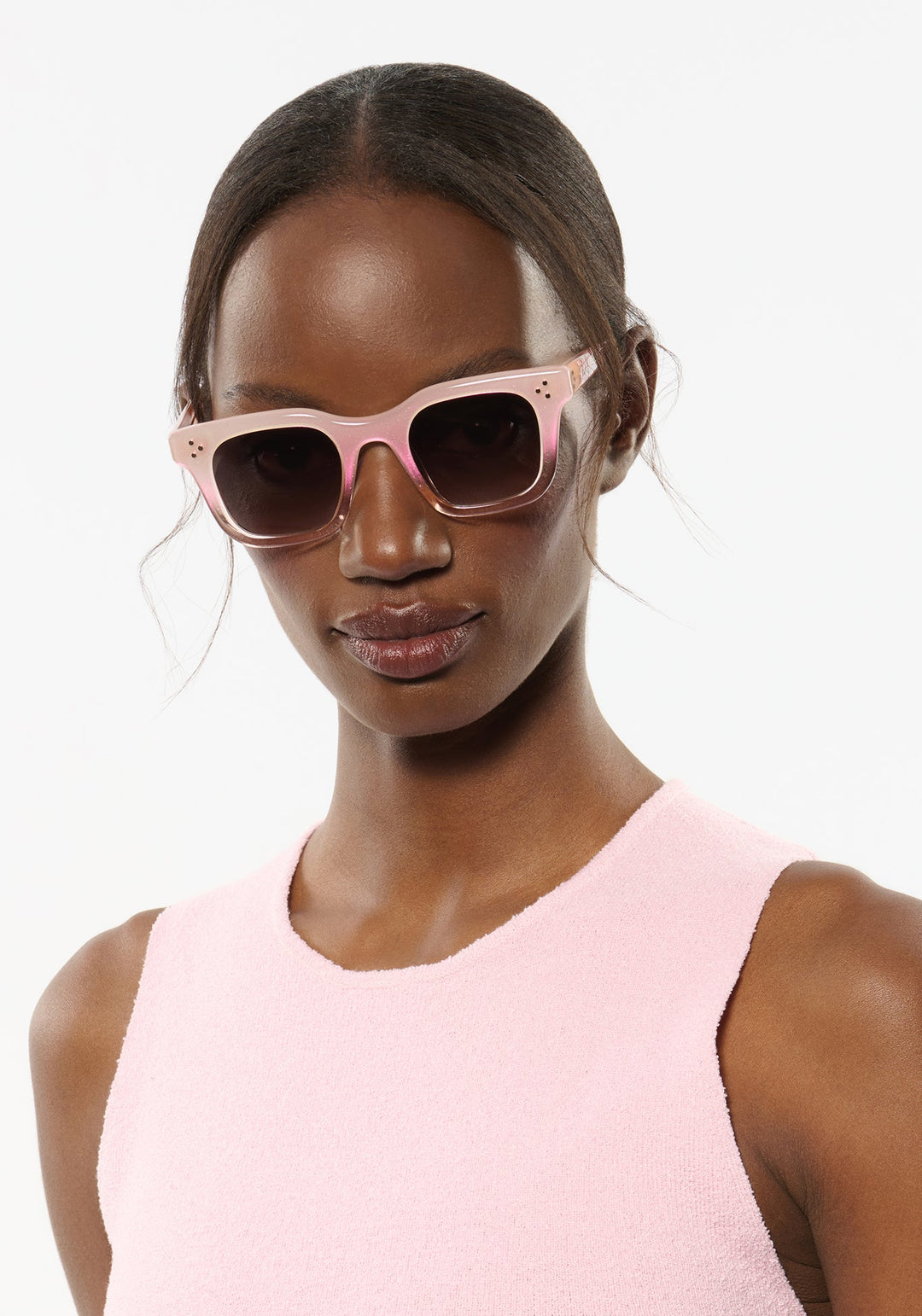 KREWE Celeste Sparkling Rose sunglasses worn by a female model, showcasing stylish accessories with sparkling rose-colored lenses.