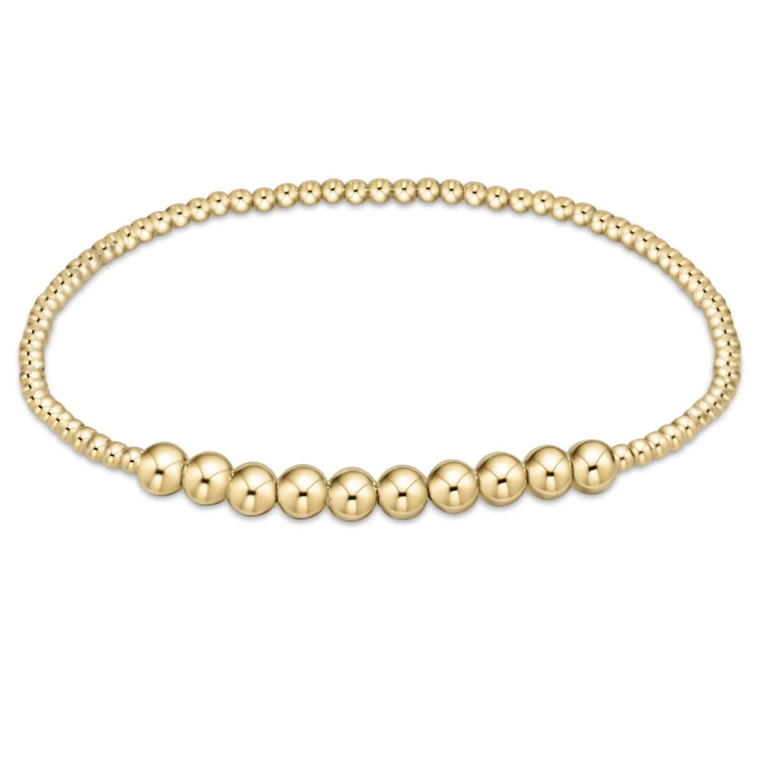 Gold beaded bracelet on a white background