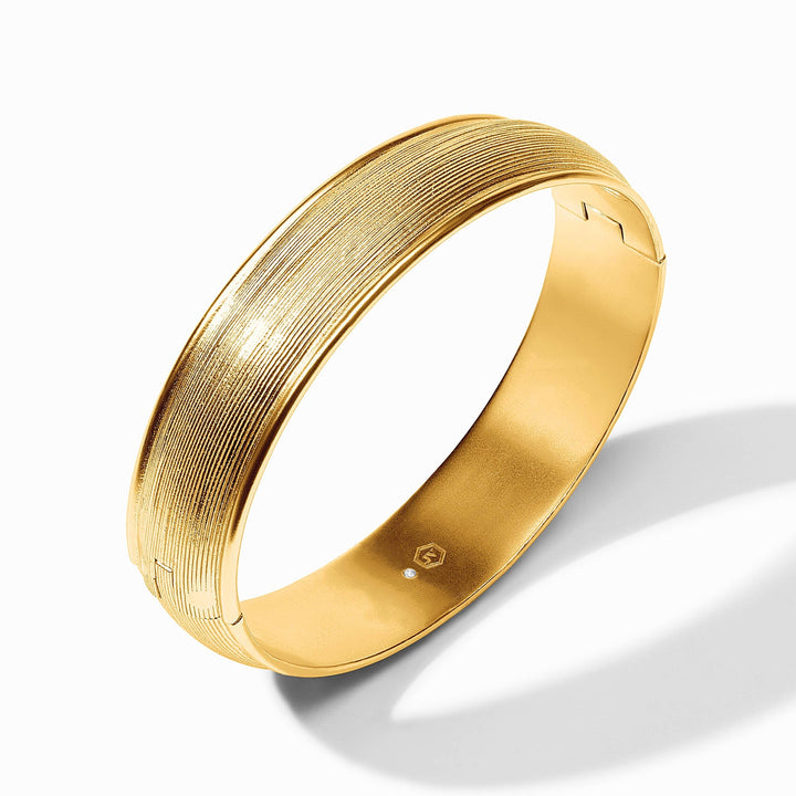 Julie Vos Cobblestone Hinge Bangle in gold, showcasing a stylish accessory with a textured cobblestone design.