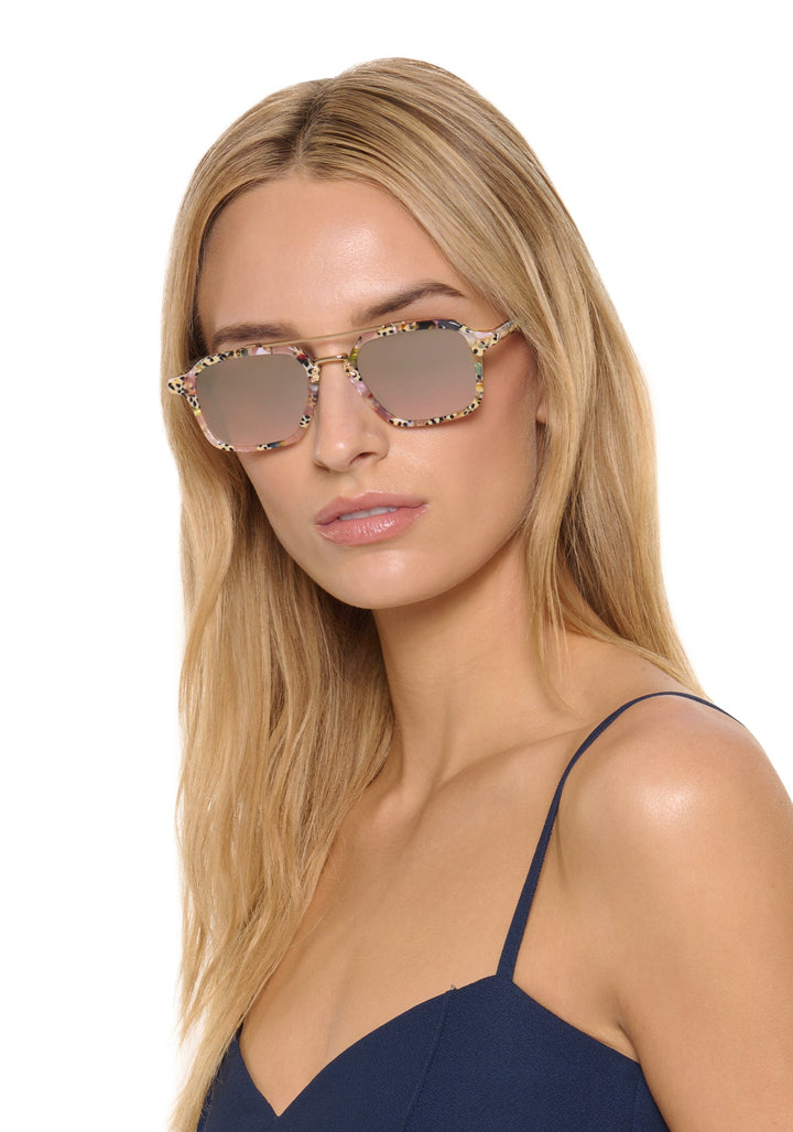 Model wearing KREWE Colton Pink Poppy mirrored aviator sunglasses
