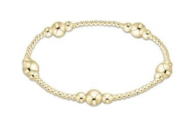 Gold bracelet with round beads on a white background