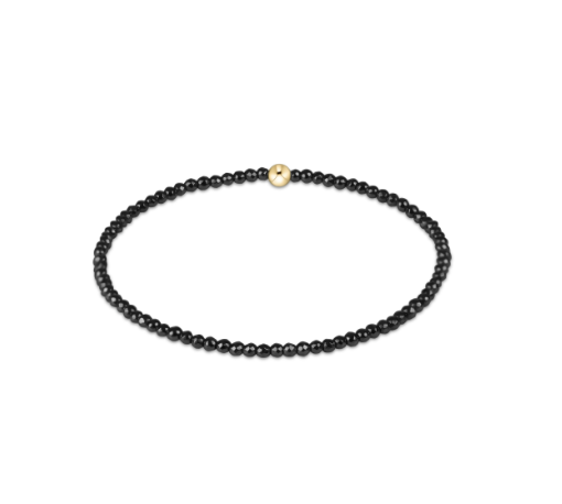 Hematite Enewton beaded bracelet with a gold bead on a white background