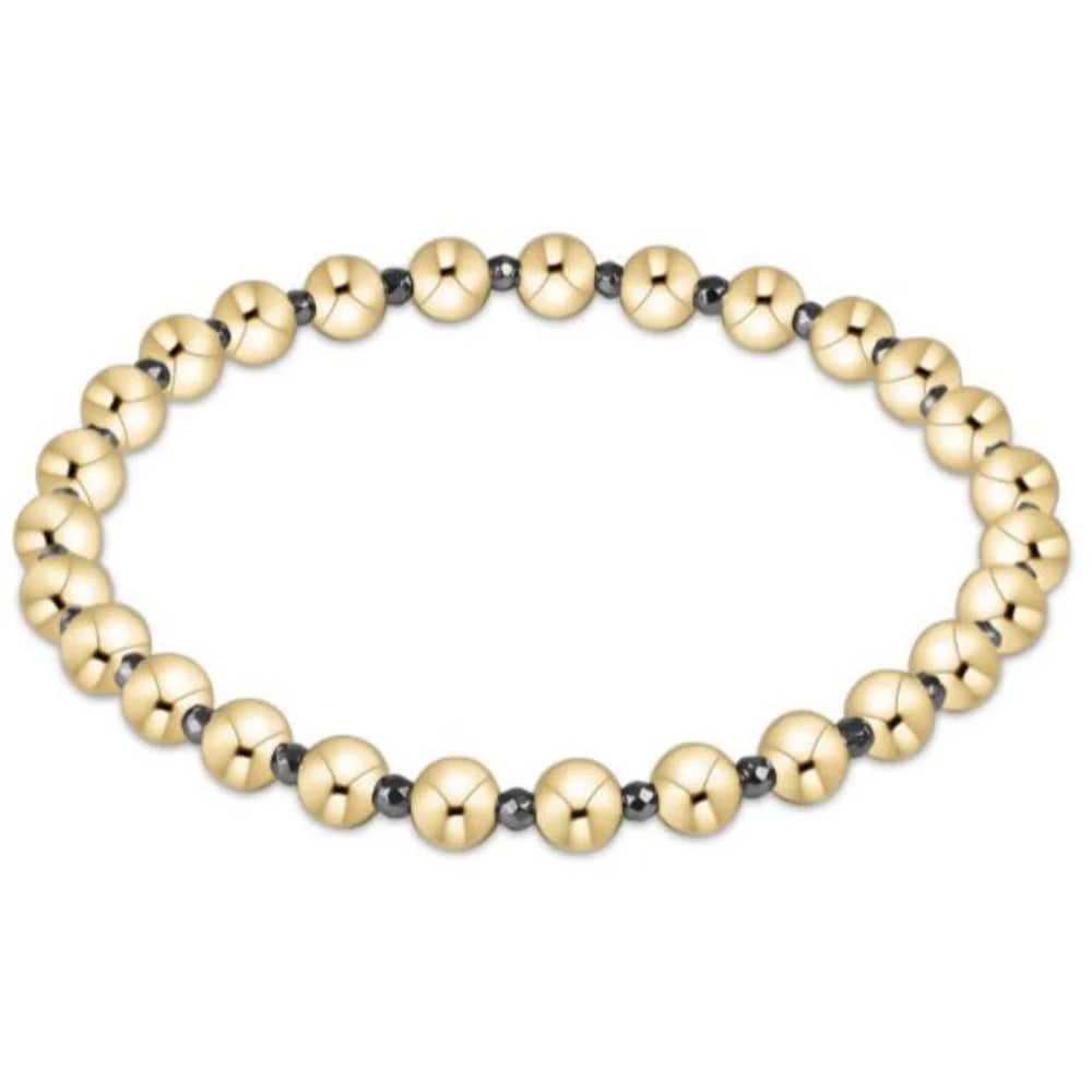 Gold beaded bracelet on a white background