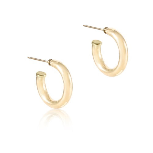 Smooth gold hoop earring on white background