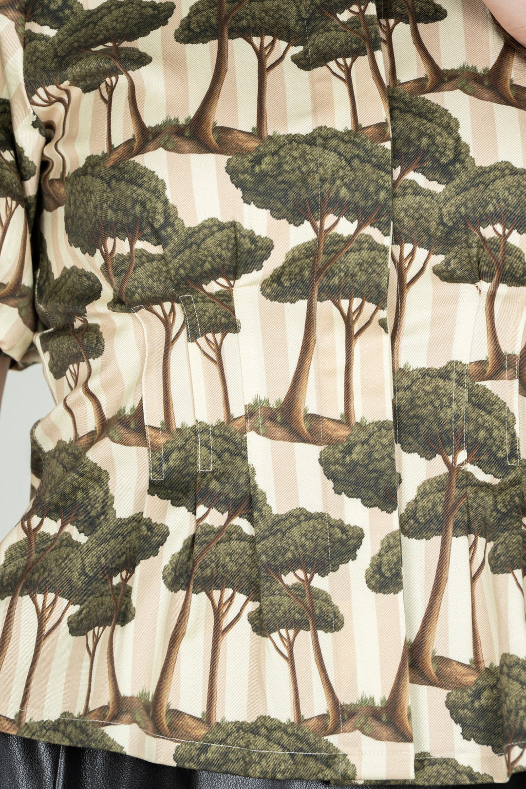 Emily McCarthy Britt Top in Umbrella Pine color, close-up detail of the stylish sleeveless blouse with intricate fabric pattern.