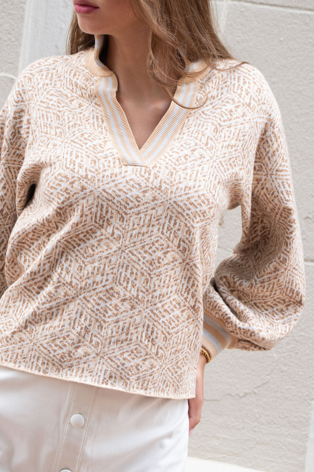 Emily McCarthy Lolli Sweater featuring a mosaic monogram design, showcased in a cozy lifestyle setting.