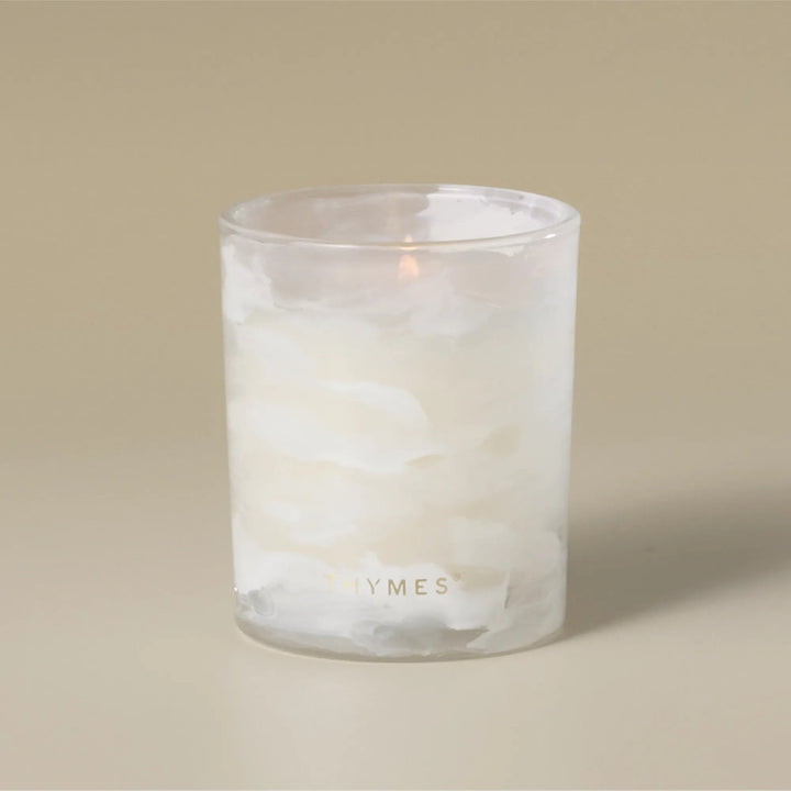 Thymes Tidings boxed candle in a decorative container, suitable for home decor and creating a cozy ambiance.