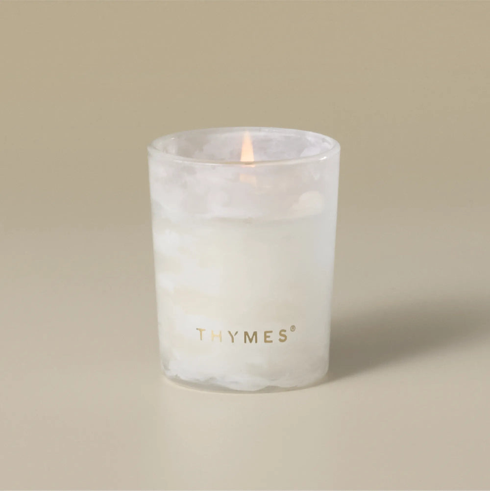 Thymes Tidings Boxed Votive candle in a decorative container, suitable for home decor or cozy ambiance.