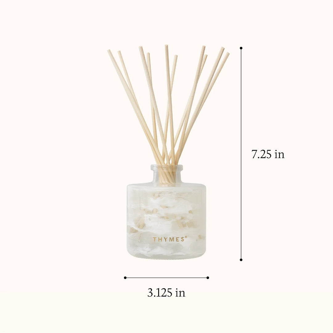 Thymes Tidings Petite Diffuser for home use, featuring a sleek design with diffuser reeds and decorative accents.