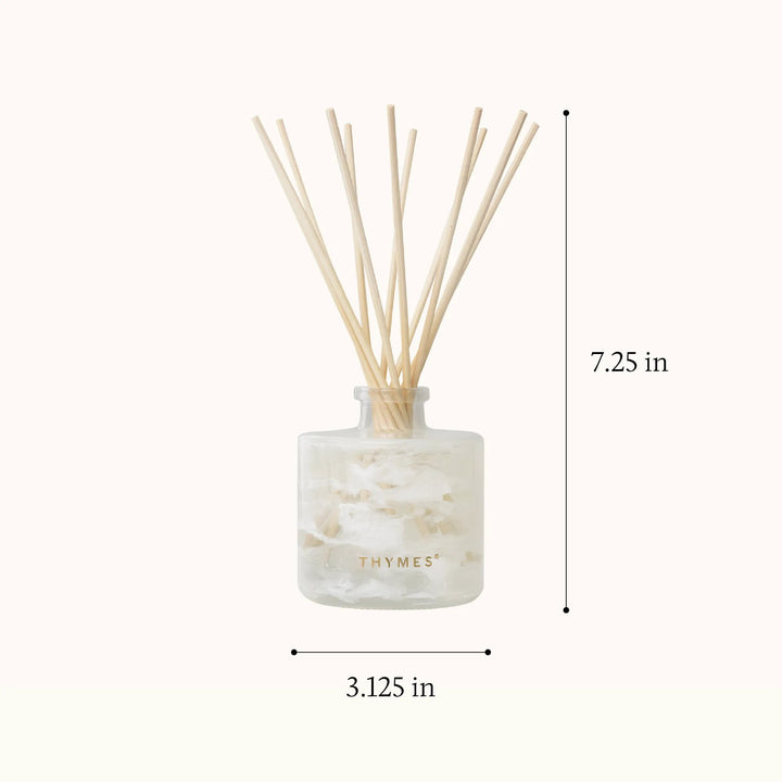 Thymes Tidings Petite Diffuser for home use, featuring a sleek design with diffuser reeds and decorative accents.