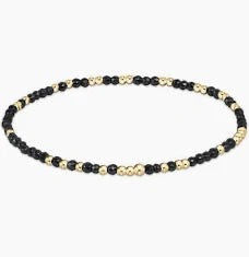 Black, gold and silver beaded bracelet e on a white background