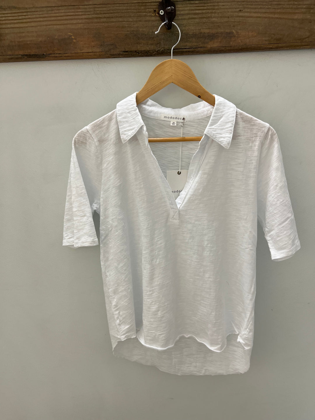 Mododoc half sleeve polo tee, stylish men's tops, featuring a classic collar and comfortable fit, shown in a casual outfit.