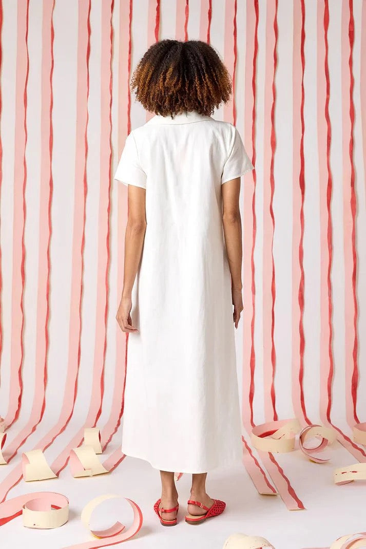 Crosby by Mollie Burch Franny Dress featuring a floral pattern, sleeveless design, and knee-length silhouette on a hanger.