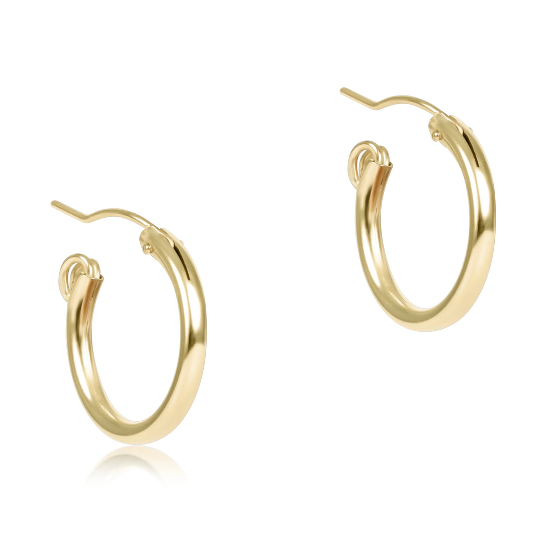 Enewton round gold hoop earrings, 0.5-inch smooth hoop accessories, close-up of shiny gold jewelry on a plain background.