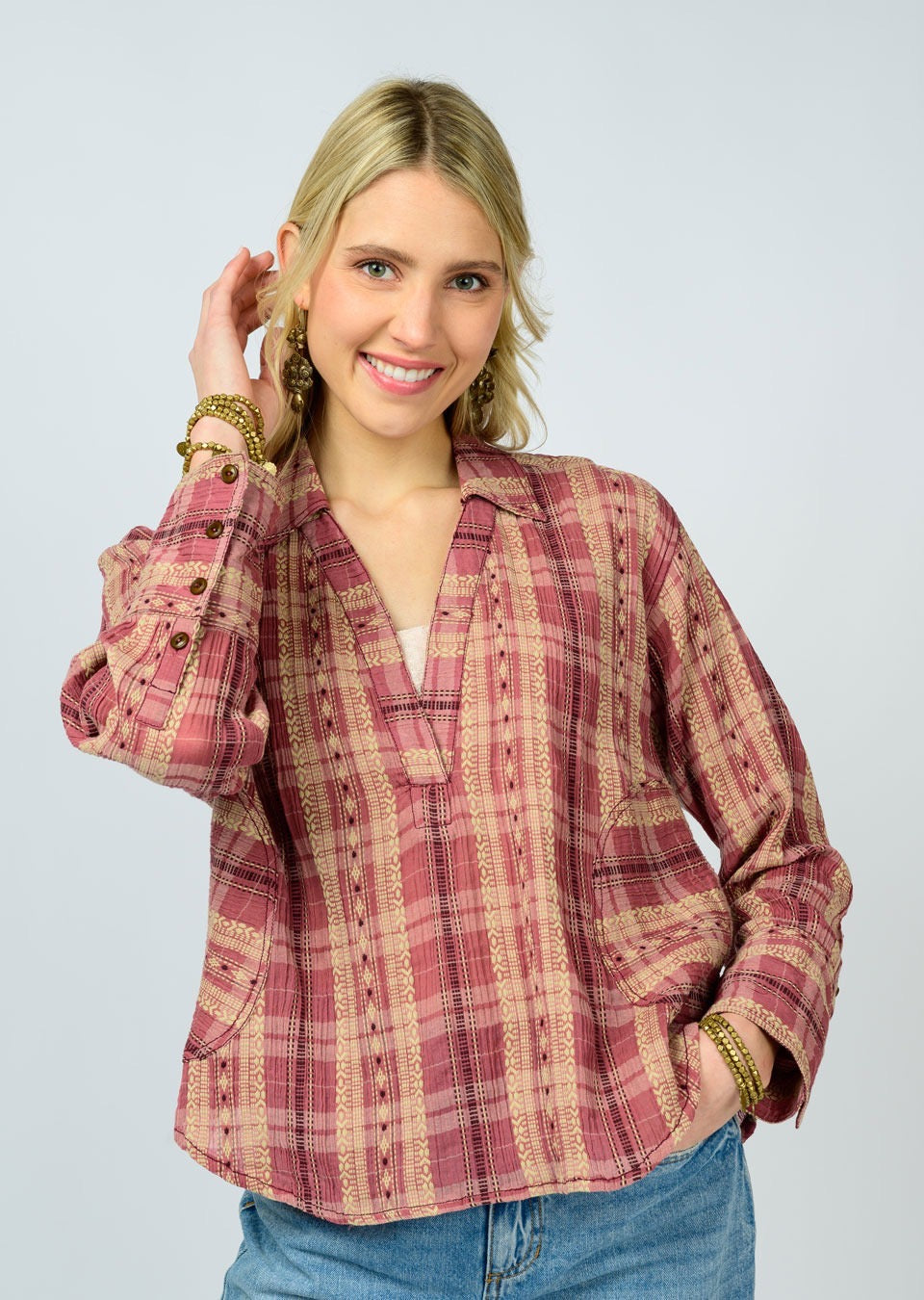 Woman wearing a plaid shirt with a plain background