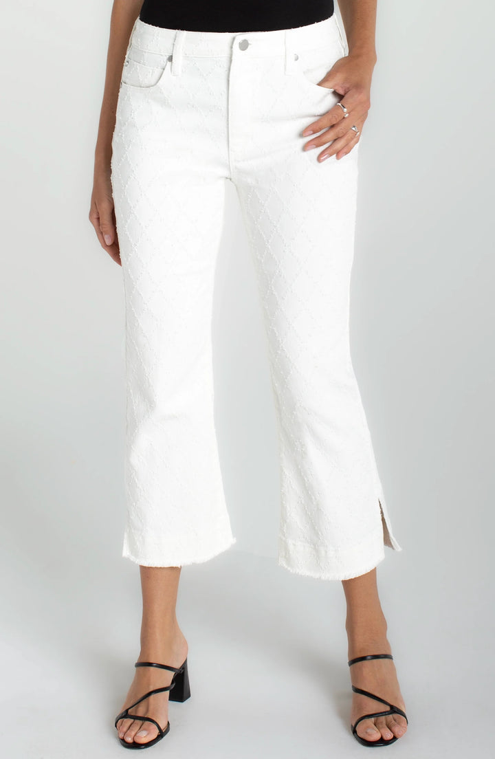 Liverpool Hannah crop flare bottoms with wide fray hem, slit detail, and white diamond accents, showcasing trendy denim design.