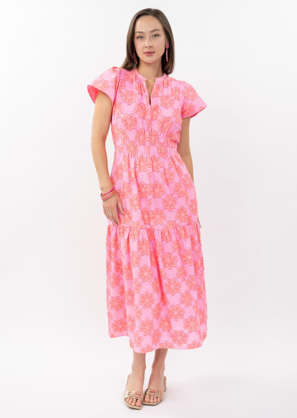 Woman wearing a pink floral dress on a white background