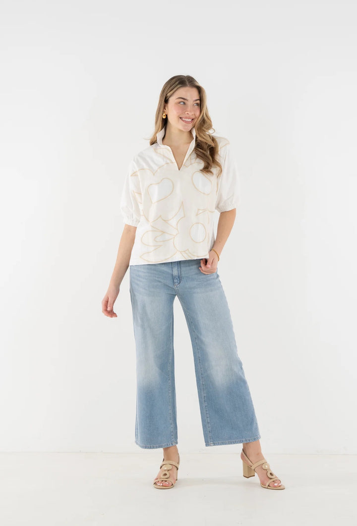 Emily McCarthy Poppy Beige Bloom Top, a stylish women's blouse with floral details and a flattering fit.