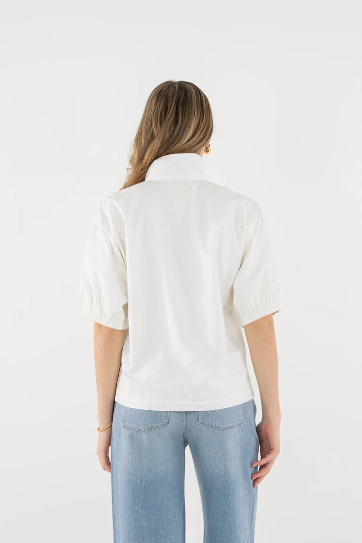 Beige bloom top from Emily McCarthy featuring floral details and a relaxed fit, perfect for casual or semi-formal wear.
