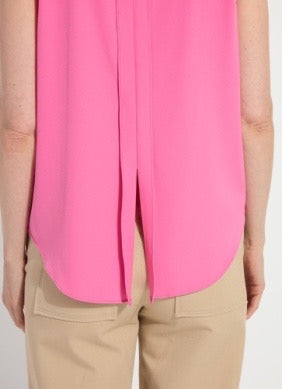 Person wearing a bright pink blouse and beige pants on a white background