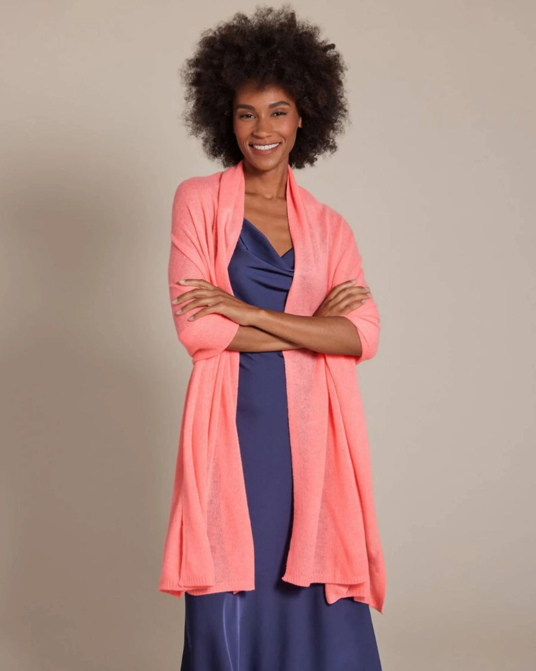 Alashan Cashmere 100% cashmere travel wrap draped over a chair, showcasing soft, luxurious fabric and versatile travel accessory.
