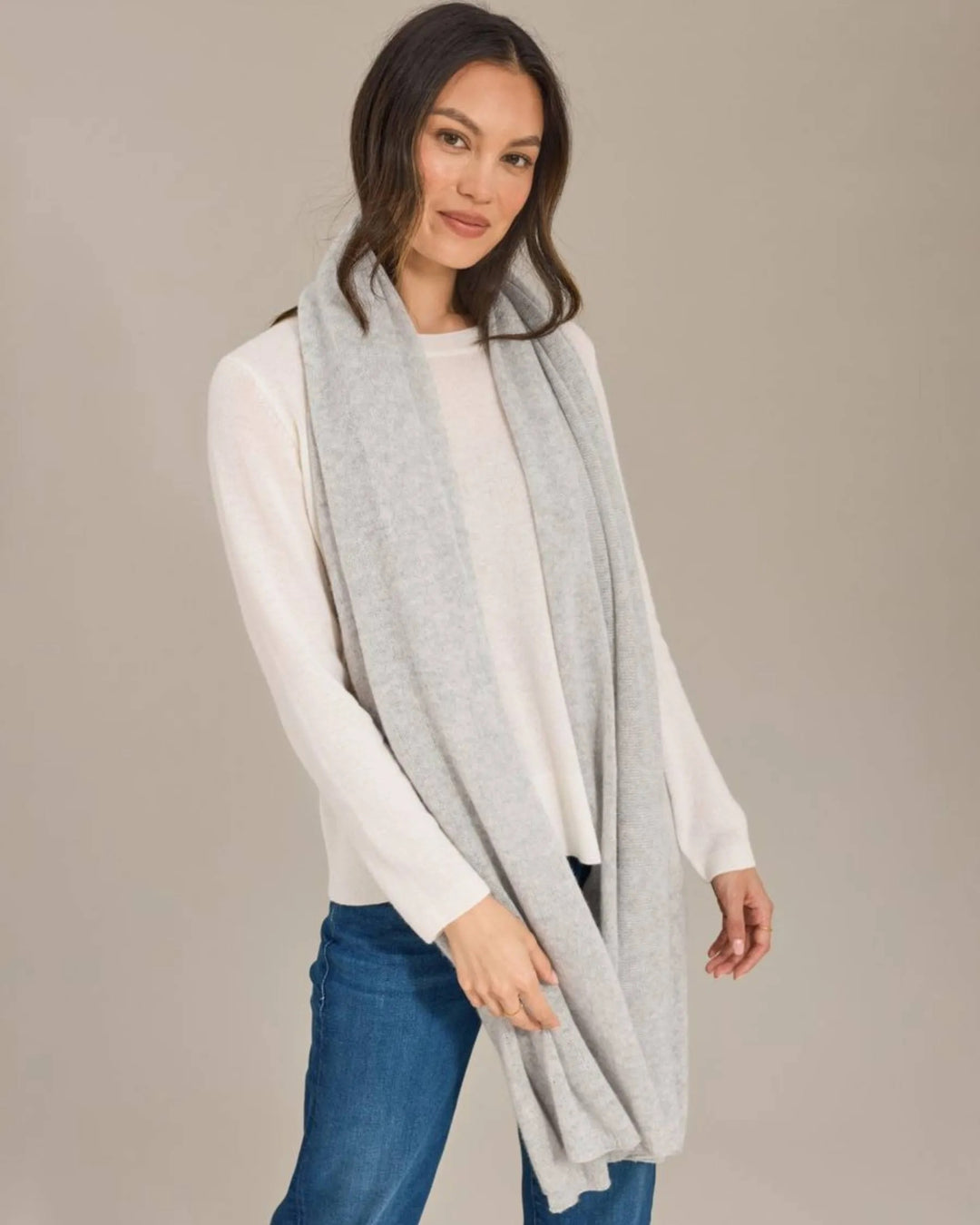 Alashan Cashmere 100% cashmere travel wrap draped over a chair, showcasing its soft, luxurious fabric and elegant design.