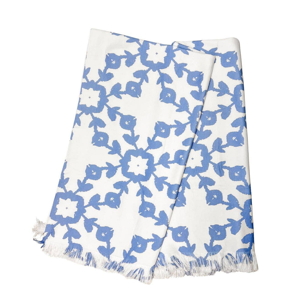 White towel with blue floral pattern on a white background