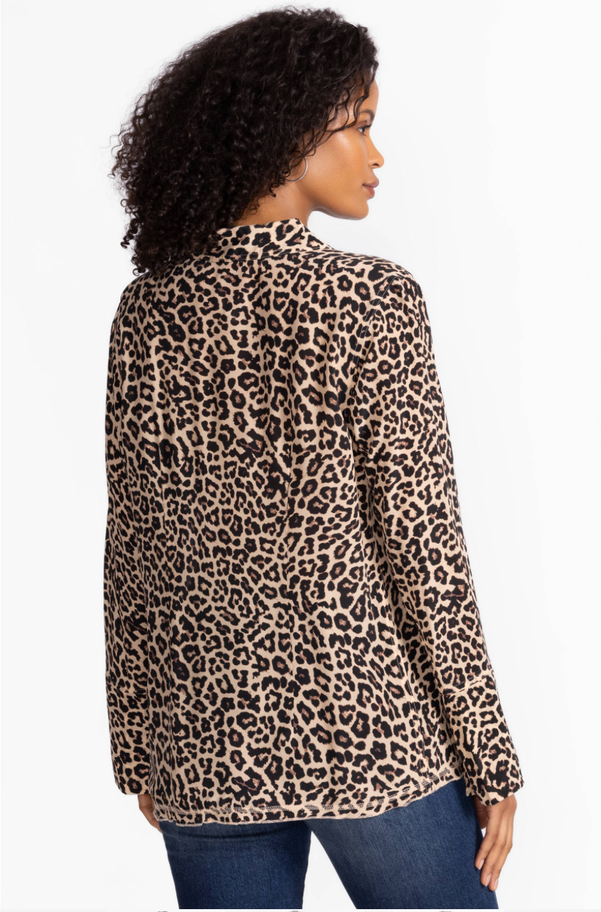 Woman wearing a leopard print long-sleeve top on a white background