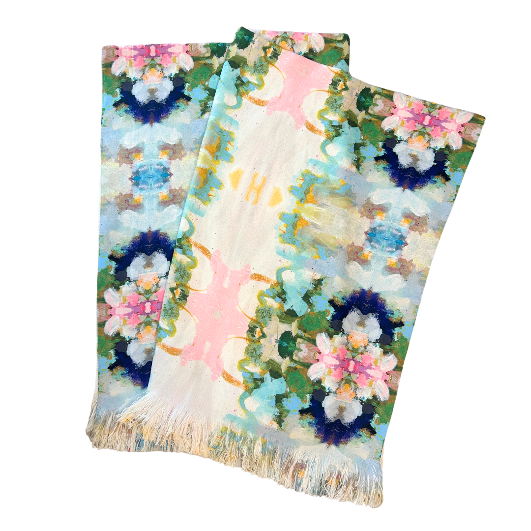 Colorful floral-patterned fabric with fringes on a white background