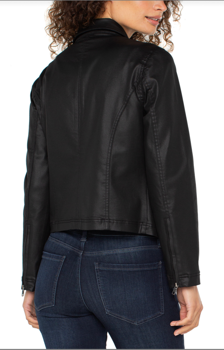 Person wearing a black leather jacket and blue jeans on a white background