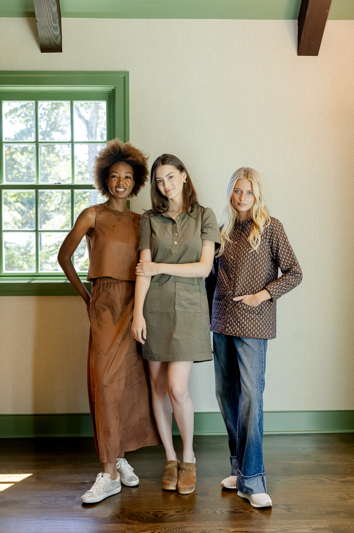 Olive corduroy shirt dress by Sail to Sable, featuring a button front, collar, and long sleeves, displayed on a hanger.