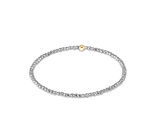 Silver beaded bracelet with a gold bead on a white background