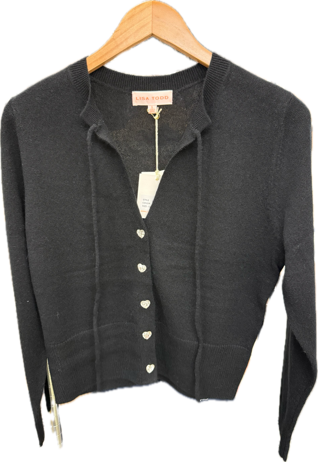 Onyx cardigan with buttons on a wooden hanger