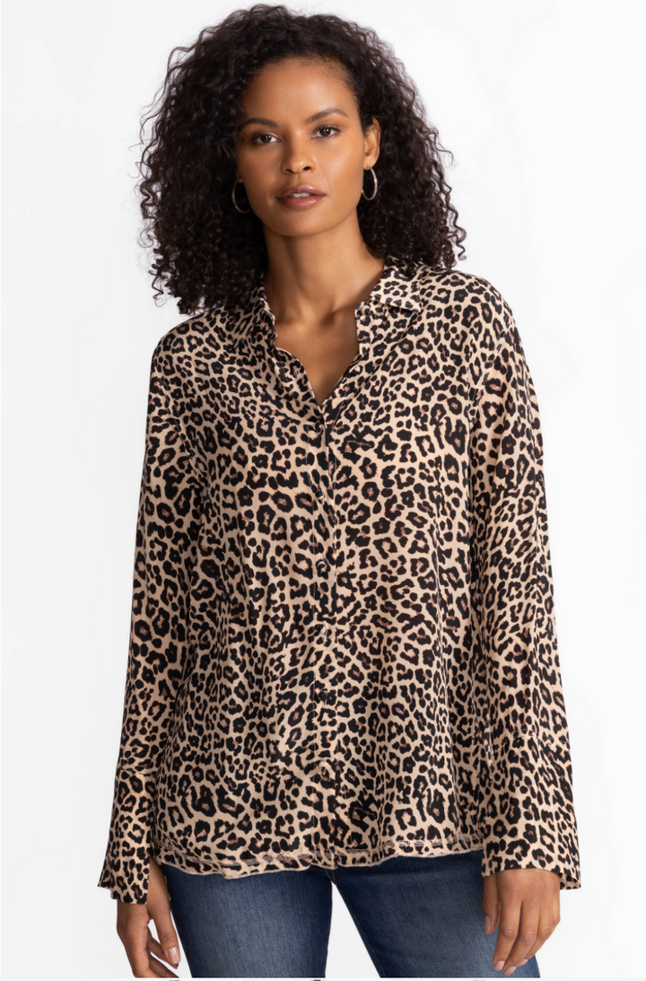 Woman wearing a leopard print blouse against a white background