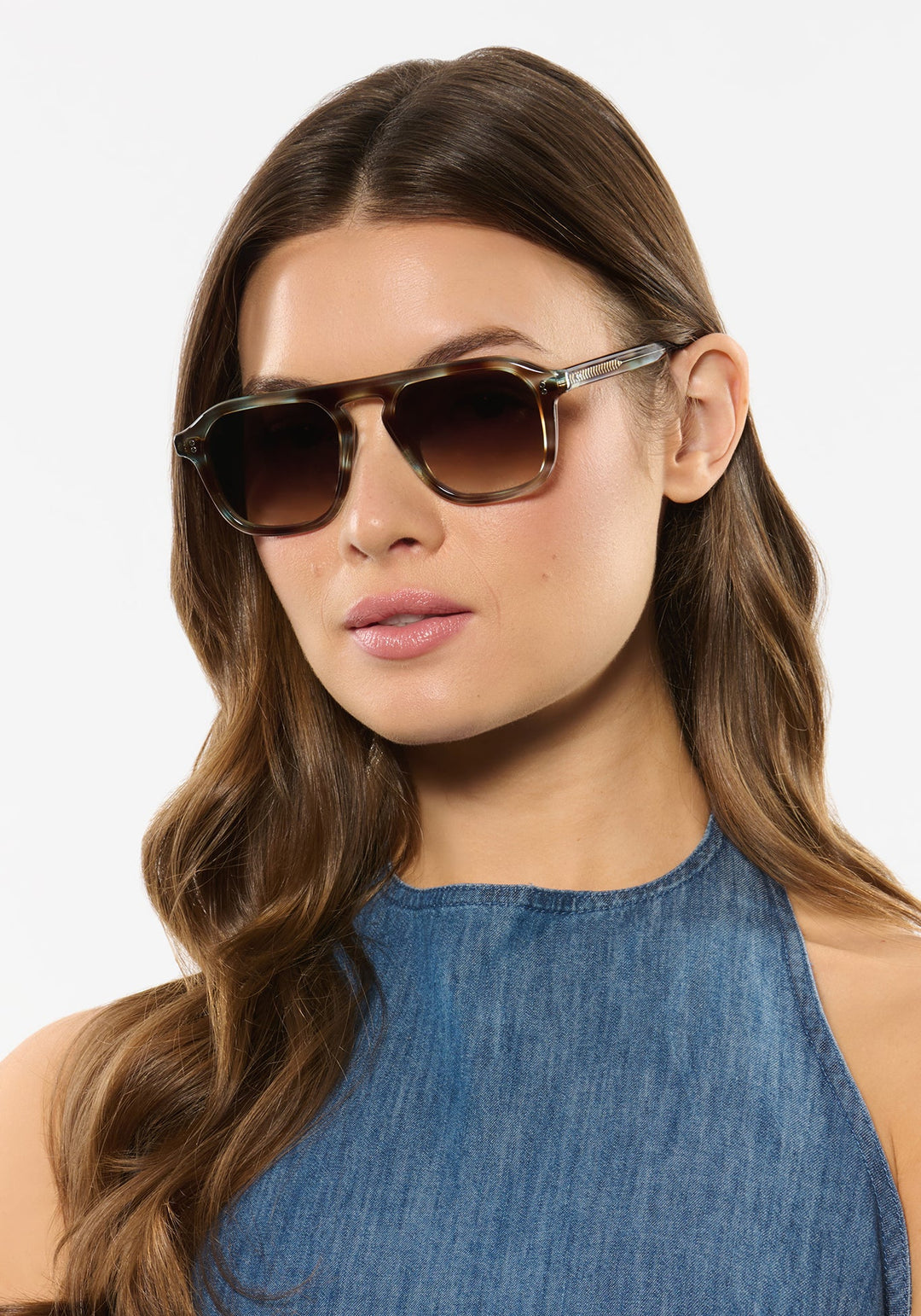 Model wearing KREWE Zander aquamarine tortoise aviator sunglasses