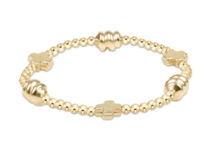 Gold bracelet with beaded design on a white background