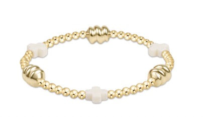 Gold and white beaded bracelet on a white background