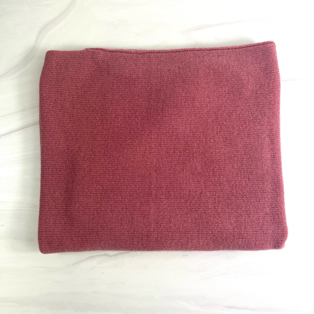Alashan Cashmere cashmere topper, soft and luxurious, draped over a top, showcasing its cozy texture and high-quality fabric.