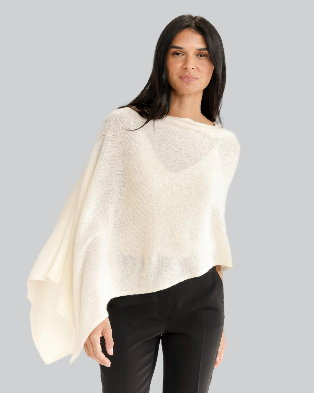 Soft beige Alashan Cashmere topper top, lightweight and luxurious, shown draped on a neutral background.