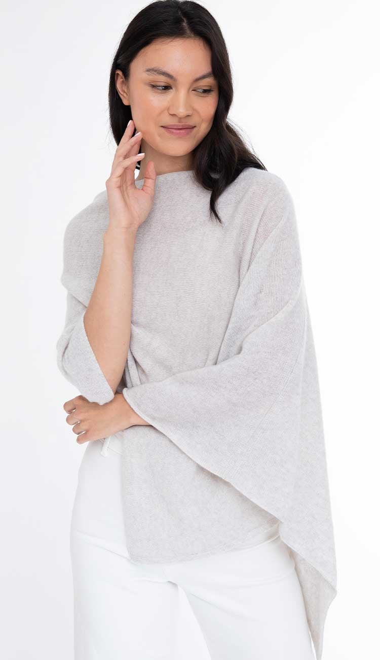 Alashan Cashmere cashmere topper top in soft, luxurious fabric, shown draped on a hanger with a cozy, elegant appearance.