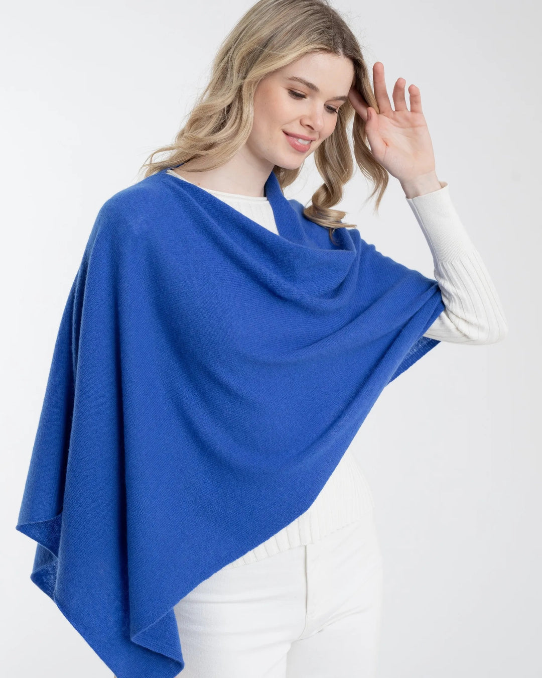 Alashan Cashmere cashmere topper displayed on a hanger, soft and luxurious fabric with a smooth, draped appearance.