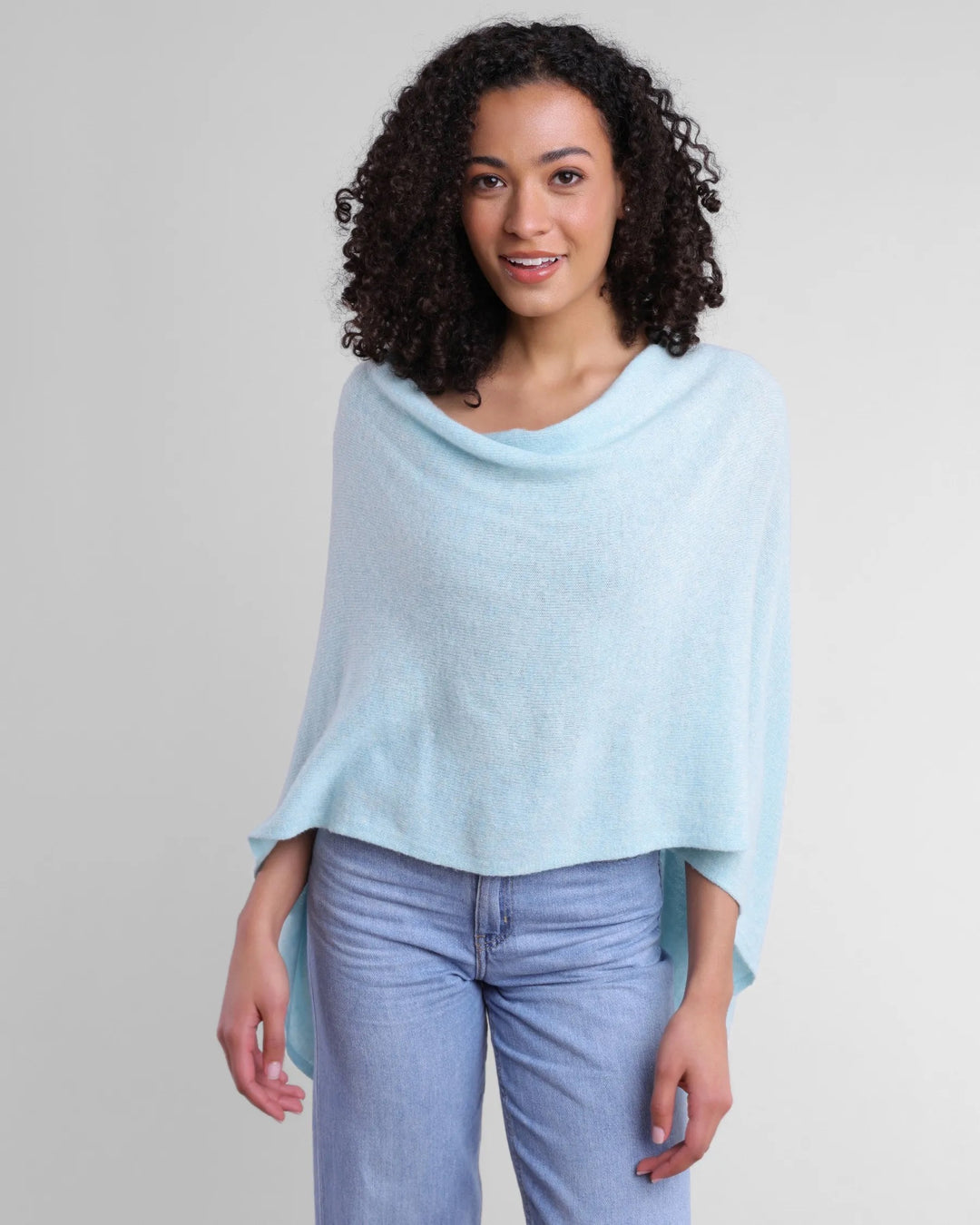 Alashan Cashmere cashmere topper top displayed on a hanger, soft fabric with a smooth texture and classic design.