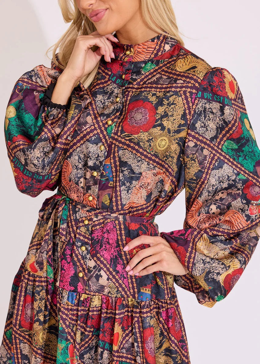 Alden Adair Adele Royalty Dress displayed on a hanger, featuring elegant fabric and intricate detailing.